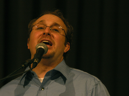 David Grimm, director of Englewood Baptist Church praise team, leads in worship during the Homecoming chapel. - Photo by Heather Phillips