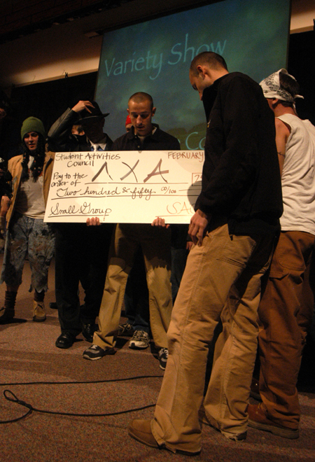 Bryan Spillman, Adam Fox, Joel Polk and Jason Polk accept the small group prize for Lamda Chi Alpha at the Variety Show. - Photo by Heather Phillips