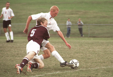 Freshman forward, Jared New, journalism major goes for a side kick as a opponent comes crashing into him. Union players beat Freed-Hardeman 9-1 scoring their second conference victory. - Photo by Kristen Hiller