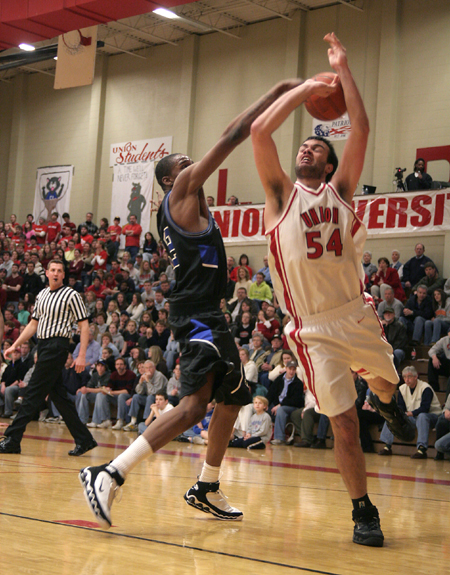 Junior Ben Frederick (54) gets fouled as he goes up for a shot in a game versus Mountain State.  - Photo by Kyle Kurlick
