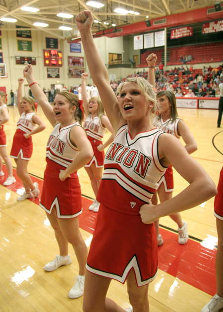 Cara Chism and the rest of the cheerleading squad helps keep the crowd's spirits high during the Homecoming game against Mountain State. - Photo by Kyle Kurlick