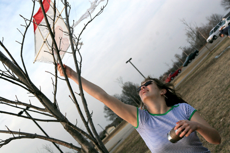 Hannah Smith untangles her kite from a tree on a windy afternoon at Union. - Photo by Kyle Kurlick