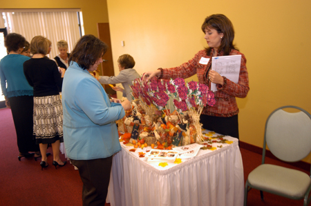 Member Ruth Phillips selects MK's and International students with the assistance of Dee Ann Culbreath.  Each fall the Auxiliary encourages members to adopt students of missionaries and international students to remember them on special events during the year. - Photo by Morris Abernathy