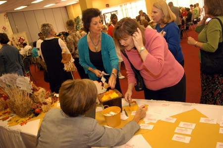 Dot Leathers, Chair of the Membership Committee, and Cindy Meredith (seated) assist guests in finding nametags during the Union Auxiliary Luncheon. - Photo by Morris Abernathy