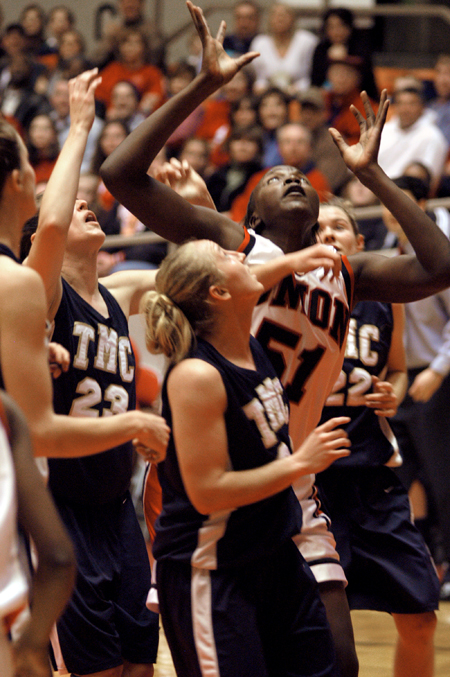 Freshman center Josephine Owino goes up for a rebound with four Master's players around her.  Union won the game 62-51 to advance to the title game in the NAIA National Tournament. - Photo by Brad Moore