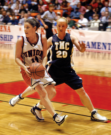 Senior guard Jennifer Henson (11) looks to pass the ball back out to the perimeter during Union's semifinal 62-51 win over The Master's College in the NAIA National Tournament. - Photo by Brad Moore
