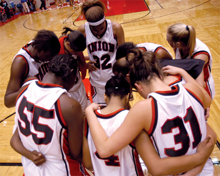 Several Union Lady Bulldog players gather for a prayer during in the NAIA National Tournament. - Photo by Brad Moore