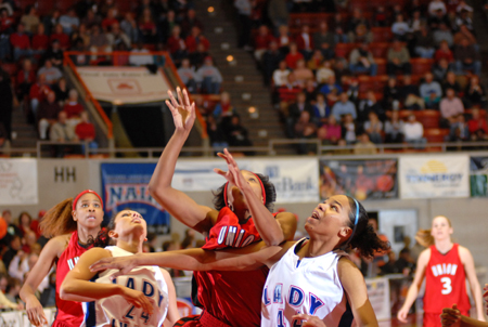 Ena Daniels (center) puts up a shot through the Lubbock Christian defense during the NAIA Women's Basketball National Championship Game. - Photo by Morris Abernathy