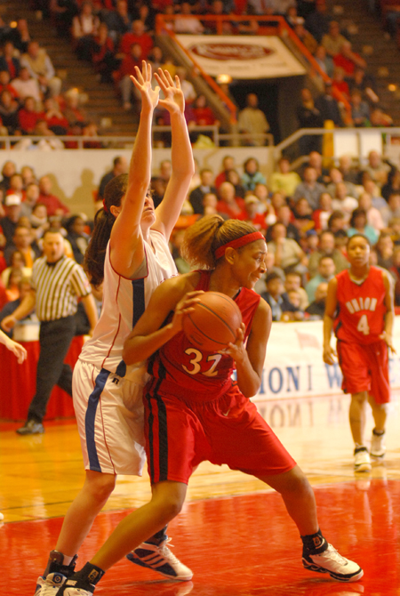 Natanya Smith (32) pivots in the paint against a Lubbock Christian defender during the NAIA Women's Basketball National Championship Game.  - Photo by Morris Abernathy