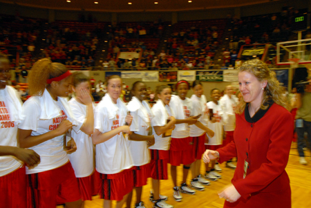 A teary-eyed Katie Woodruff, Lady Bulldog assistant coach, receives her national championship trophy following the Lady Bulldogs' win against Lubbock Christian. - Photo by Morris Abernathy