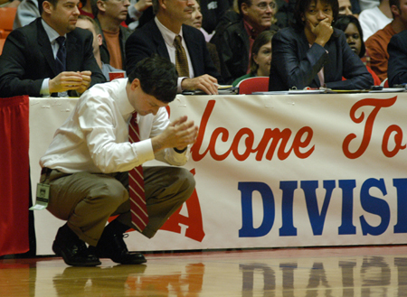 Head Coach Mark Campbell ponders from the sidelines during the NAIA Women's Basketball National Championship Game.  - Photo by Jim Veneman