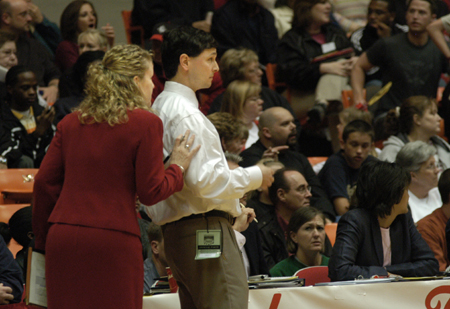 Assistant Coach Katie Woodruff consults with Head Coach Mark Campbell on the sidelines during the NAIA Women's Basketball National Championship Game.  - Photo by Jim Veneman