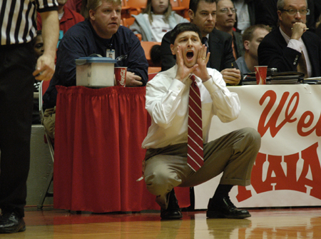 Head Coach Mark Campbell gives encouragement from the sidelines during the NAIA Women's Basketball National Championship Game.  - Photo by Jim Veneman