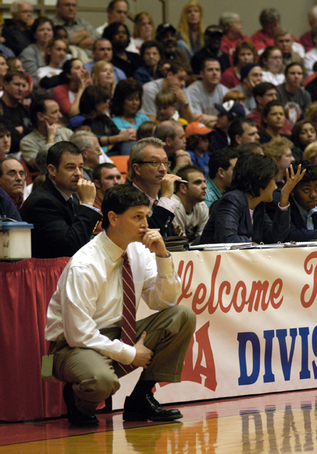 Head Coach Mark Campbell focuses on the game from the sidelines during the NAIA Women's Basketball National Championship Game.  - Photo by Jim Veneman