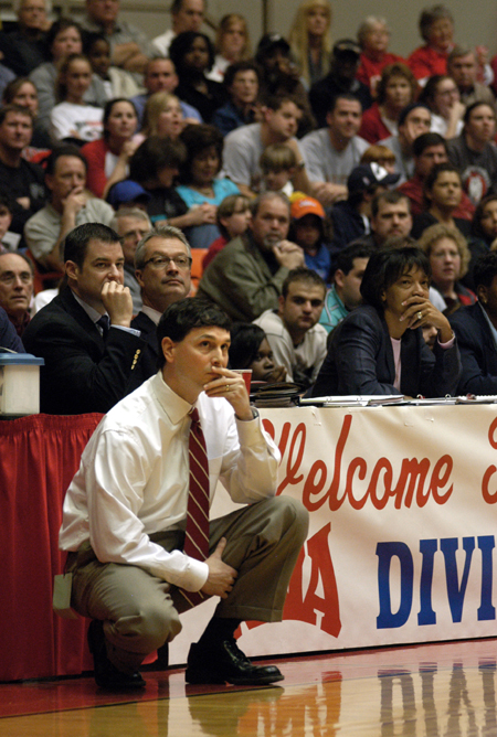Head Coach Mark Campbell focuses on the game from the sidelines during the NAIA Women's Basketball National Championship Game. - Photo by Jim Veneman