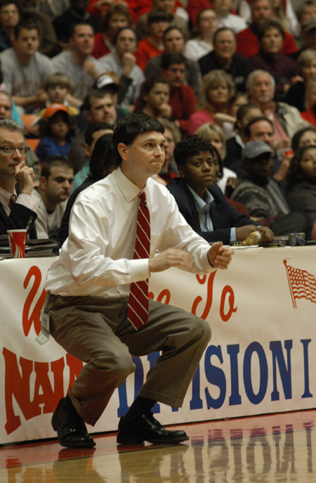 Head Coach Mark Campbell rises with intensity during the NAIA Women's Basketball National Championship Game. - Photo by Jim Veneman