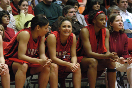 Senior Jennifer Henson sneaks a smile to the crowd during the final minutes of the NAIA Women's Basketball National Championship Game. - Photo by Jim Veneman