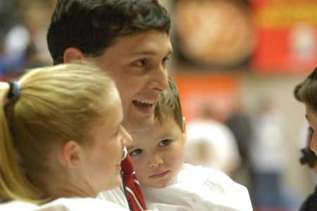 Sophomore guard Crystal Eason joins head coach Mark Campbell and his son Gray in celebrating Union's second consecutive NAIA national championship. - Photo by Jim Veneman