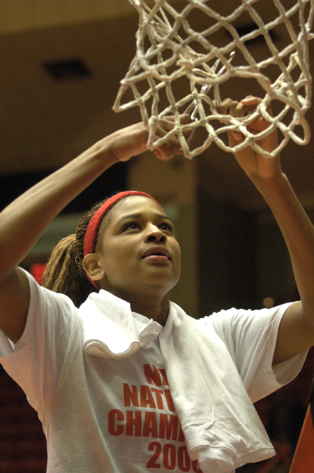 Junior center Natanya Smith helps cut down the nets following Union's 79-62 victory over Lubbock Christian. The win gave the Lady Bulldogs a second consecutive NAIA national championship. - Photo by Jim Veneman