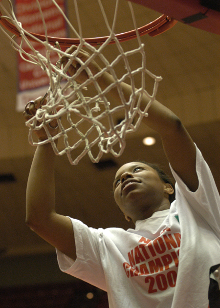 Freshman guard Jessica Graves cuts down a piece of the net after Union's second straight NAIA National Title.  Union topped Lubbock Christian 79-62 to capture the championship. - Photo by Jim Veneman
