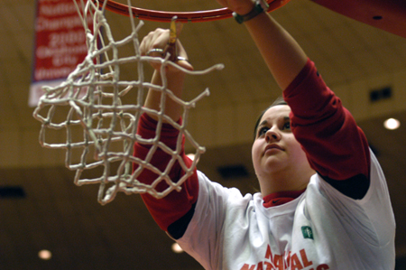 Student assistant Joanna Vaughan helps cut down the nets after Union's 79-62 victory over Lubbock Christian. The Lady Bulldogs secured their second consecutive NAIA national championship with the win. - Photo by Jim Veneman