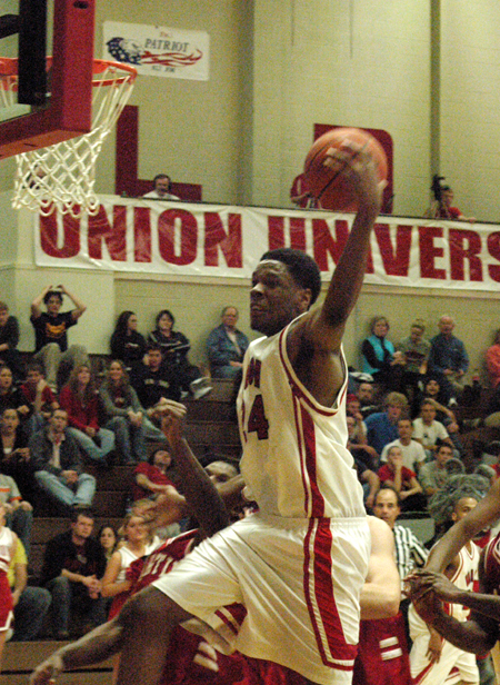 Deywane Lee (24) snatches a rebound out of mid air in Union's win over Martin Methodist. - Photo by Steven Aldridge