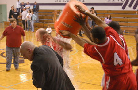 Chris Williams (4) and Corey Burkett (45) douse Union head coach Ralph Turner with the remaining contents of the water cooler following Union's second straight TranSouth Tournament Title.  Union's TV Broadcaster Steve Beverly gets caught in the mix. - Photo by Steven Aldridge