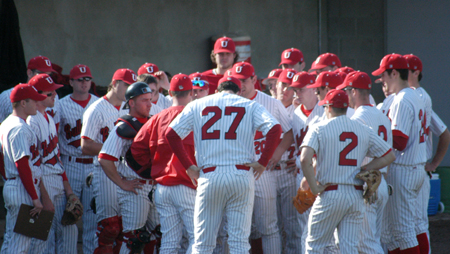 The Bulldogs huddle between innings. - Photo by Steven Aldridge