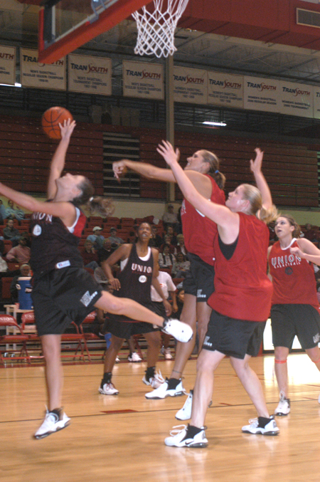 Junior Ginger Bryant blocks the shot of freshman Jennifer Henson in the women's scrimmage during Midnight Madness.
 - Photo by Jim Veneman