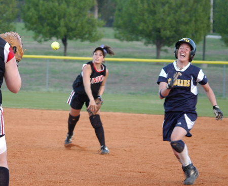 Candace Cross throws behind a runner attempted to complete a double-play after catching a line-drive. - Photo by Steven Aldridge