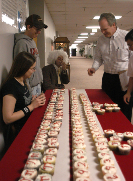 Students celebrated Einstien's birthday and Pi Day by handing out cupcakes displaying multiple digits of pi and by having an Einstein look-a-like contest. Jim Kirk, computer science professor, went for one of the lower numbers. - Photo by Heather Phillips