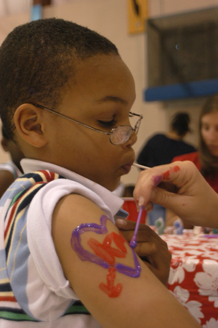 A young man gets a lollypop and an arm painting at the Jackson Boys & Girls Club during The Spring Fling. - Photo by Heather Phillips