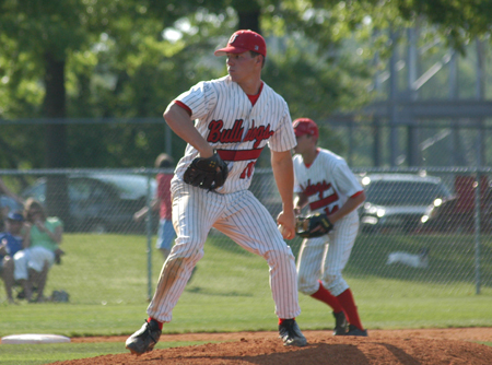 Sophomore Judson Powers of Humboldt, Tennessee delivers a pitch to the plate during weekend series at Union's Fesmire Field.  Fellow sophomore, also a native of Humboldt, James Brasfield gets ready on defense at third base. - Photo by Steven Aldridge