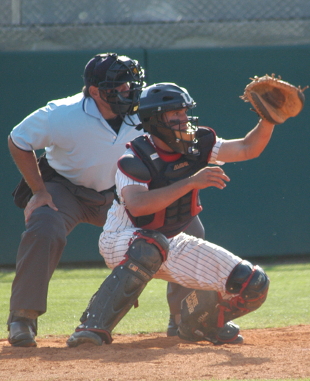Freshman catcher Allen Williams adjusts his position behind the plate to make a play on high pitch. - Photo by Steven Aldridge