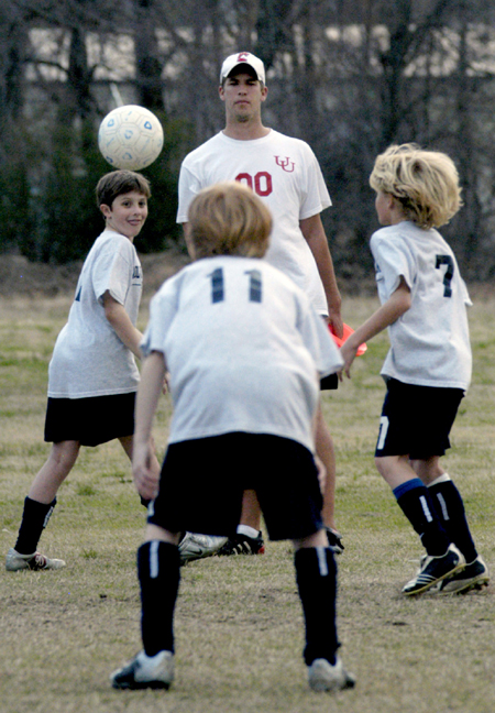 Chris Lean, physical education major, coaches the Jackson Wolves 95 in preparation for the National Championship Games. - Photo by Stephanny Rodriguez