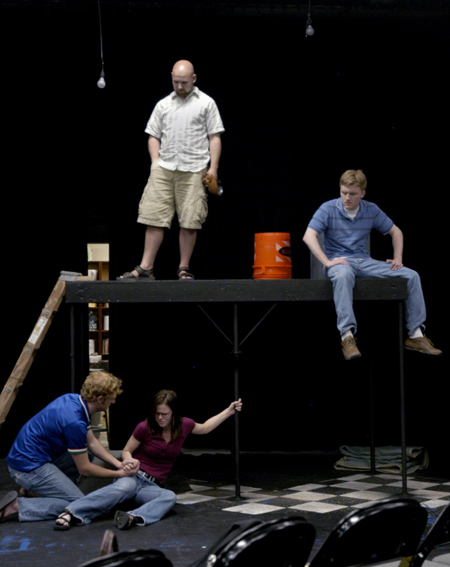 Zuss and Nickels look down on Job and Sarah, played
by Jared New and Courtney Braswell, at the end of Act I during practice for the theatre's production of <em>J.B.</em>. - Photo by Stephanny Rodriguez