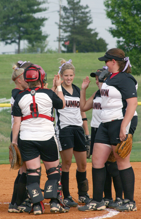 The infield rallies at the mound to offer words of encouragement against Martin Methodist. The softball team is currently second in the conference behind Trevecca Nazarene University. - Photo by Stephanie Schroeder