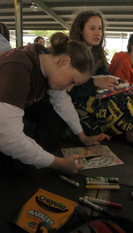 Katie Stephens and Kathleen Lokey make fliers during the Invisible Children Global Night Commute to send to U.S. lawmakers urging them to take action against the genocide happening in Sudan and Uganda. - Photo by Heather Phillips
