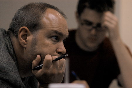 Chris Nadaskay, professor of art, analyzes a digital media presentation during the Scholarship Symposium. - Photo by Heather Phillips