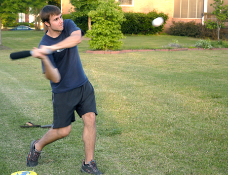 Chad Glenn takes a swing during a baseball game with classmates at President Dockery's house during Happy Trails, a farewell event for graduating seniors sponsored by Young Alums. - Photo by Brad Moore