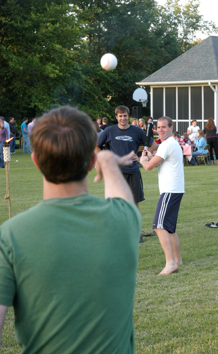 Landon Preston pitches to Nathan Hooper while Chad Glenn watches at President Dockery's house during Happy Trails, a farewell event for graduating seniors sponsored by Young Alums. - Photo by Brad Moore