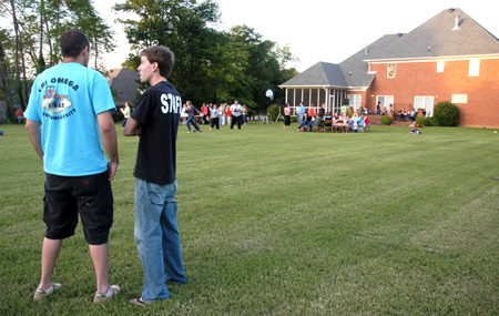 Brad Spencer (right) talks with Chris Pashley (left) at President Dockery's house during Happy Trails, a farewell event for graduating seniors sponsored by Young Alums. - Photo by Brad Moore