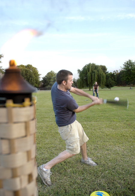 Jared Lawrence takes a swing in a game of baseball with classmates at President Dockery's house during Happy Trails, a farewell event for graduating seniors sponsored by Young Alums. - Photo by Brad Moore