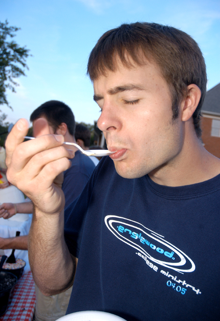 Chad Glenn enjoys a spoonful of ice cream at President Dockery's house during Happy Trails, a farewell event for graduating seniors sponsored by Young Alums. - Photo by Brad Moore
