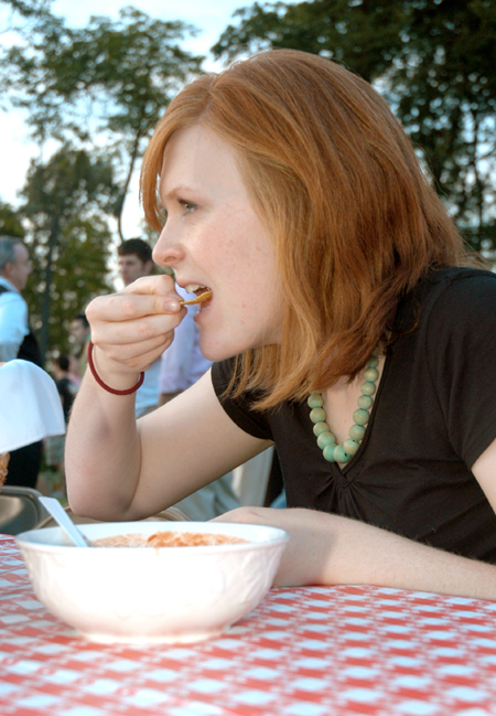 Alice Calvery enjoys a bite to eat at President Dockery's house during Happy Trails, a farewell event for graduating seniors sponsored by Young Alums. - Photo by Brad Moore