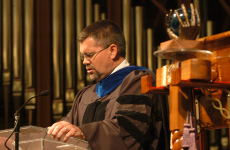 Chris Hail, faculty member of the year and associate professor of mathematics, opens the Awards Day ceremony with prayer. - Photo by Heather Phillips