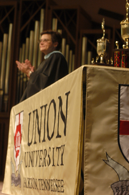 Registrar Jane Betts distributes the academic medals and other awards during the Awards Day ceremony. - Photo by Heather Phillips