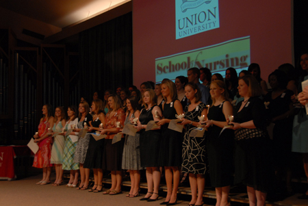 The BSN Class of 2006 displays their lamps as they prepare to enter the nursing world. - Photo by Morris Abernathy