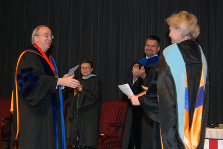 President Dockery congratulates English professor Pam Sutton, who was named Faculty Member of the Year at the Awards Day chapel service May 10.  - Photo by Morris Abernathy