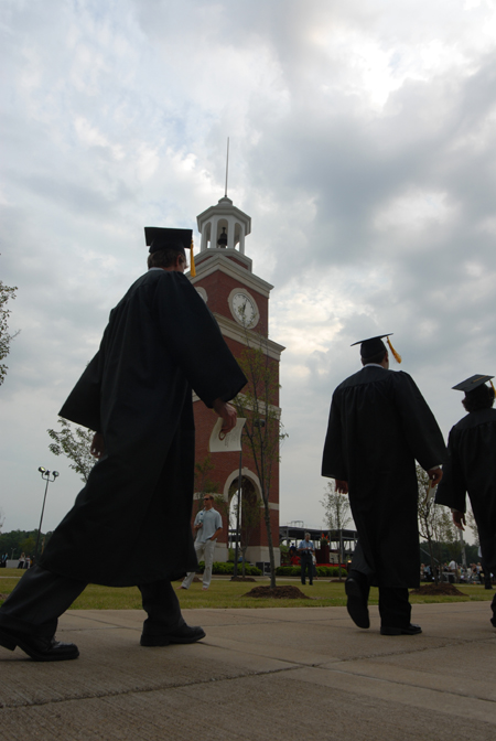 Graduates filed past Miller Tower on their way to the spring graduation ceremony. - Photo by Morris Abernathy